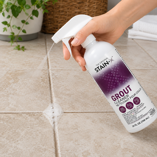 Stain-X Grout Cleaner 24 oz being sprayed on a grout line on a tile floor